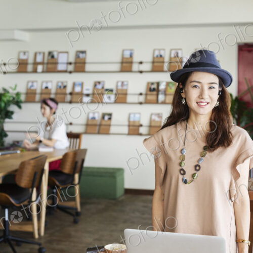 Group of young Japanese professionals working on laptop computers in a co-working space. Group of young Japanese professionals working on laptop computers in a co-working space.
