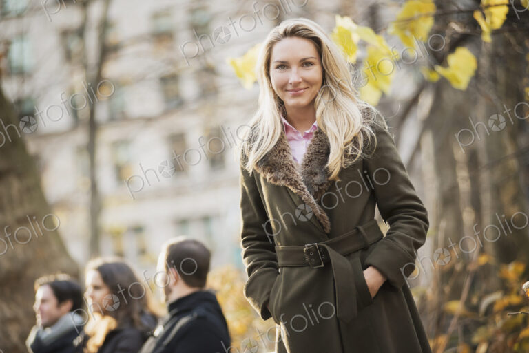Group on bench in urban park, woman in front
