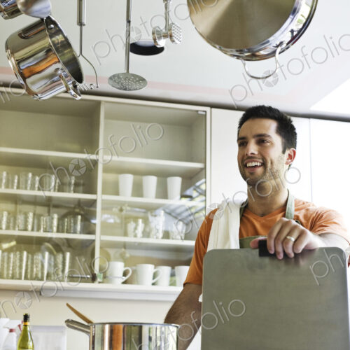 HIspanic couple at home in their kitchen. HIspanic couple at home in their kitchen.