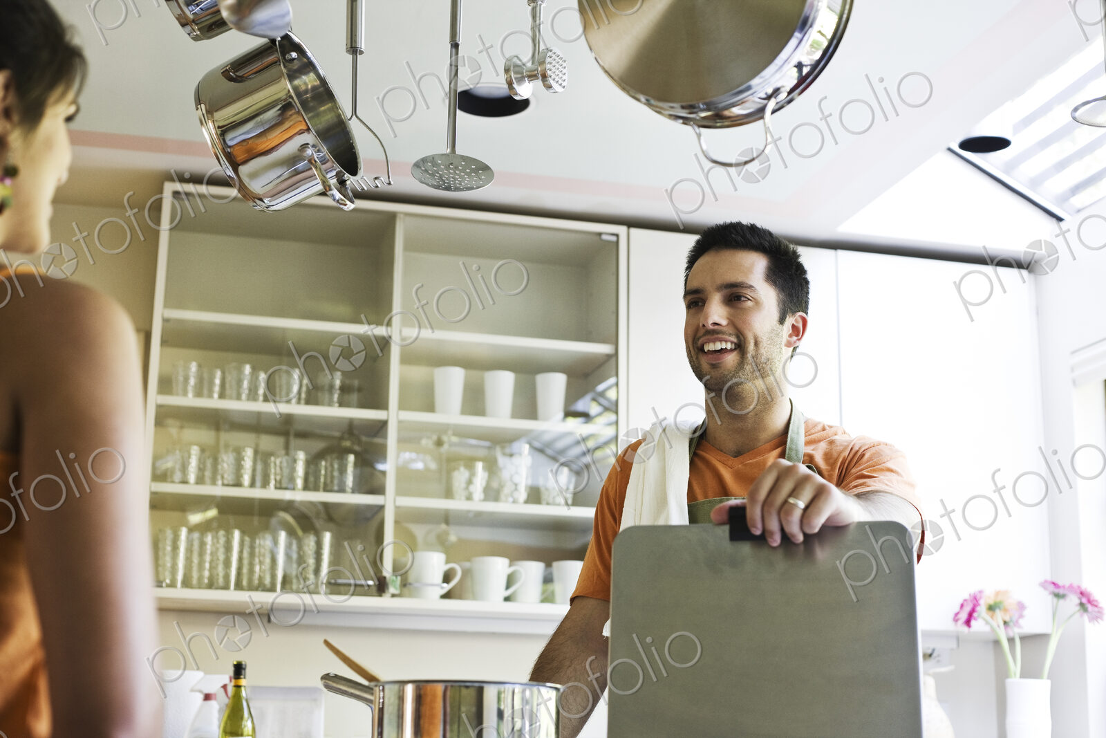 HIspanic couple at home in their kitchen.