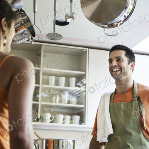 HIspanic couple at home in their kitchen. HIspanic couple at home in their kitchen.