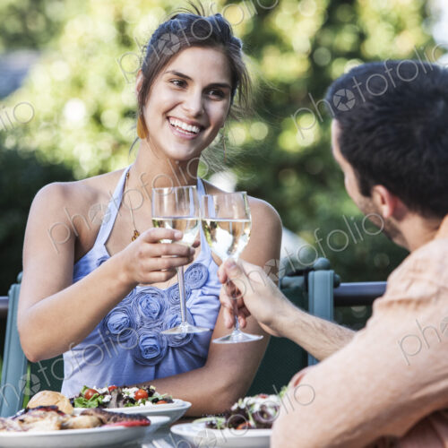 HIspanic couple having a healthy meal and a glass of white wine. HIspanic couple having a healthy meal and a glass of white wine.