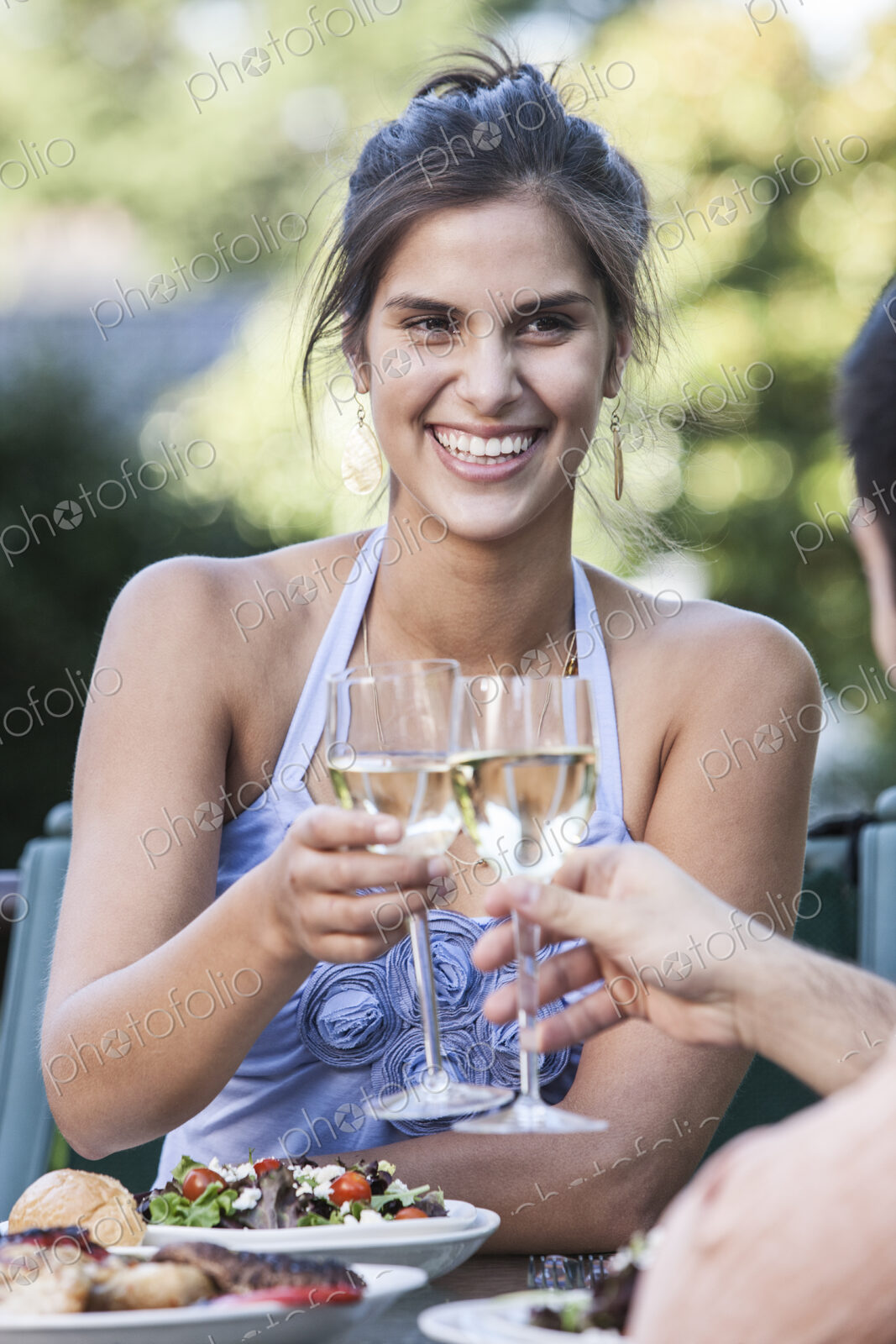 HIspanic couple having a healthy meal and a glass of white wine.