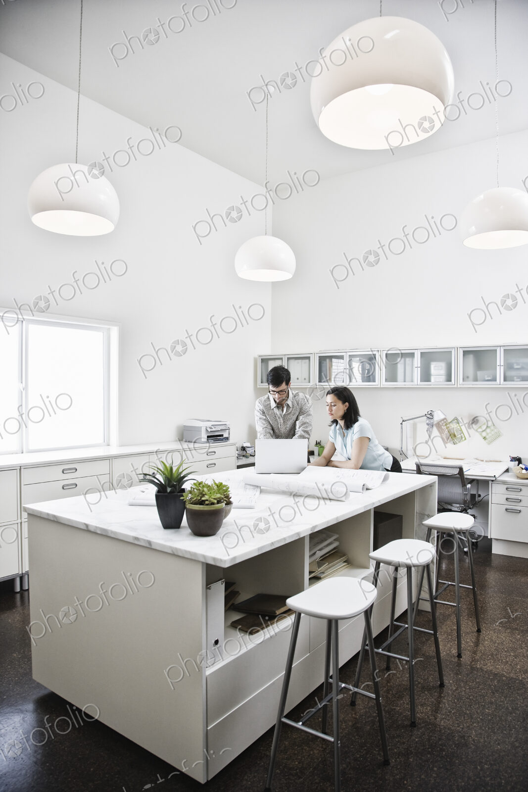 HIspanic man and woman working together in an architect’s office.