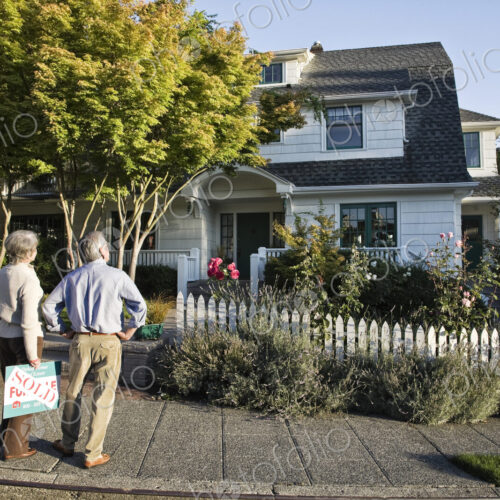 HIspanic seniors in front of their newly puchased remodeled older style home. HIspanic seniors in front of their newly puchased remodeled older style home.