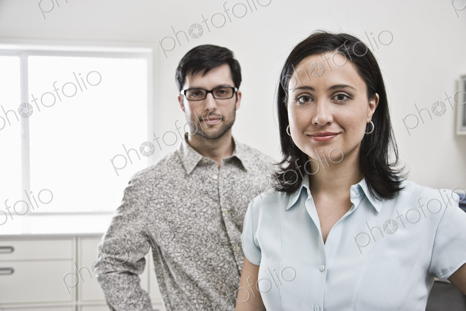 HIspanic woman and man in office.
