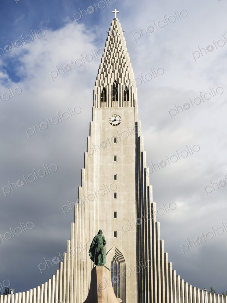 Hallgrímskirkja church, a tall modern church tower and statue of the explorer Leif…