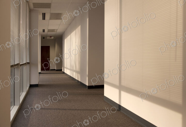Hallway of an office building, sunlight coming through miniblinds.