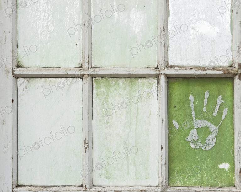 Hand Print on a Greenhouse Windowpane