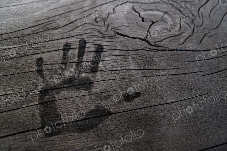 Hand print on wooden surface.