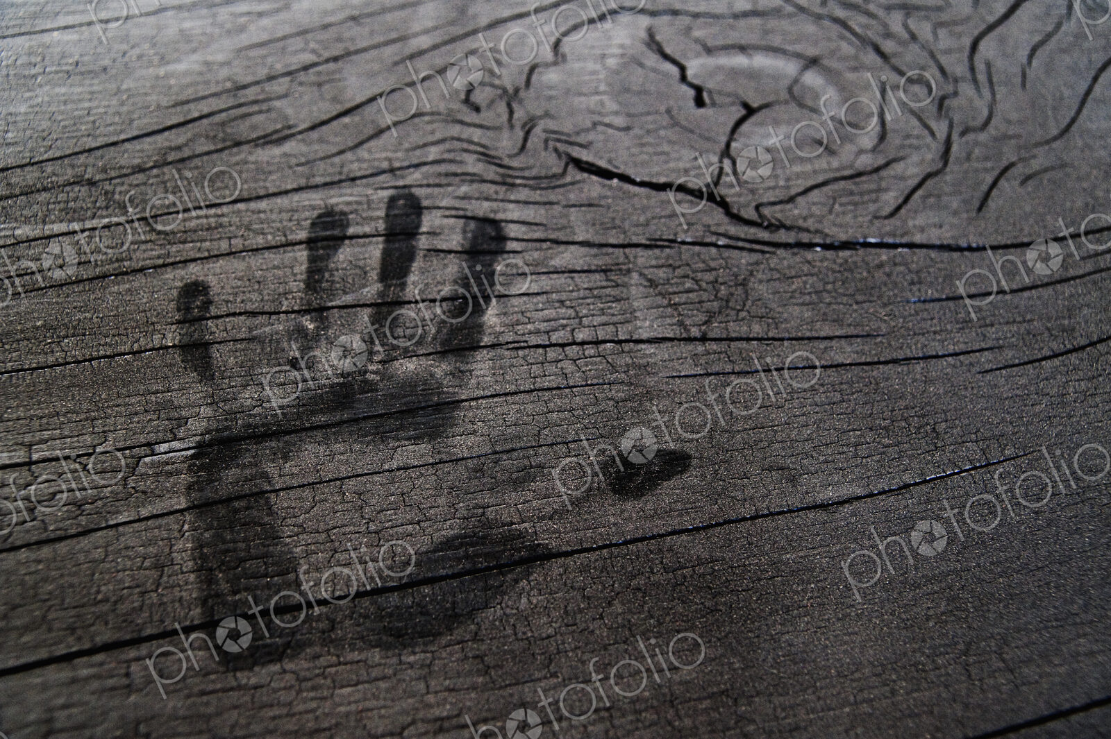 Hand print on wooden surface.