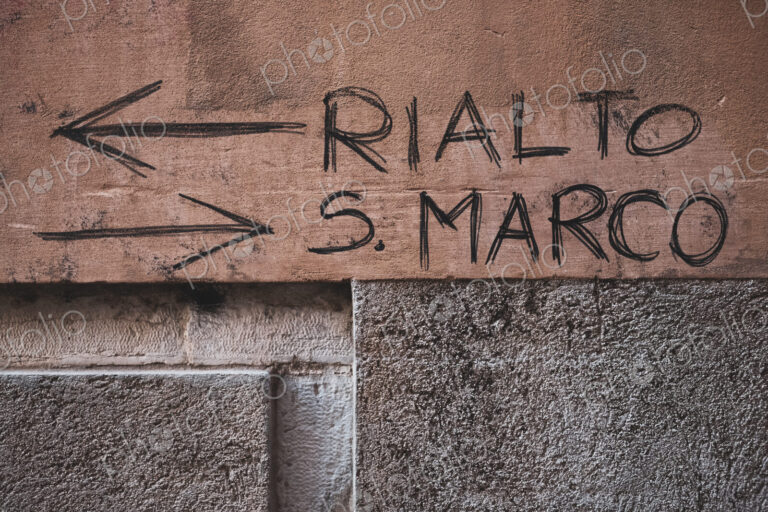 Handwritten directions to the Rialto and San Marco on a wall in Venice, Veneto, Italy.