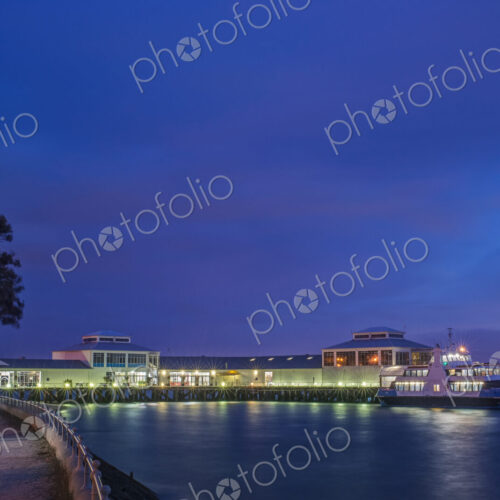 Harbor and boat lit up at dusk