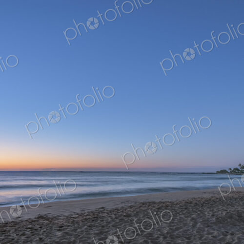 Hawaii, Kauai, Wailua Beach at dawn, the sun on the horizon, view out to sea. Hawaii, Kauai, Wailua Beach at dawn, the sun on the horizon, view out to sea.
