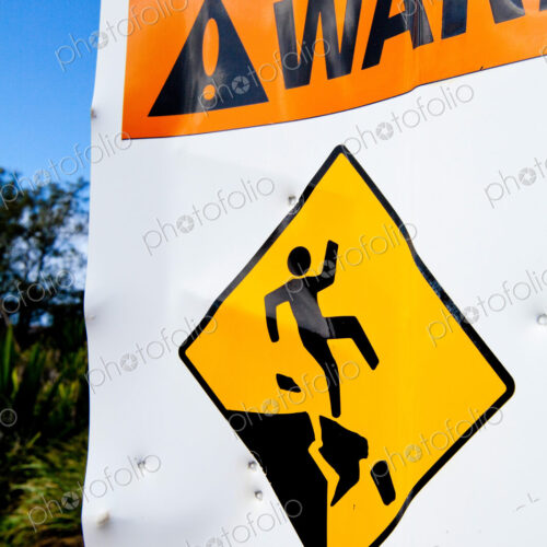 Hazard sign of danger, cliffs and an image of a person falling. Hazard sign of danger, cliffs and an image of a person falling.