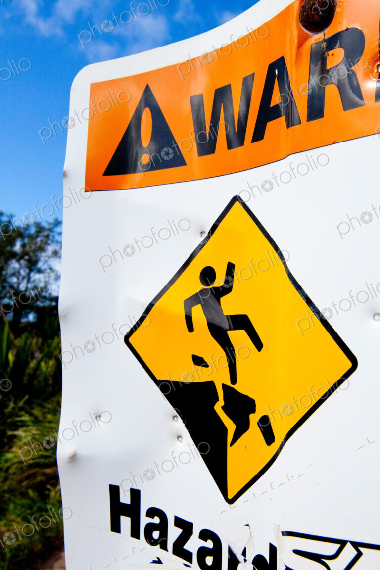 Hazard sign of danger, cliffs and an image of a person falling.