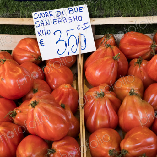High angle close up of Cuore di Bue, beef tomatoes, at an Italian market stall. High angle close up of Cuore di Bue, beef tomatoes, at an Italian market stall.