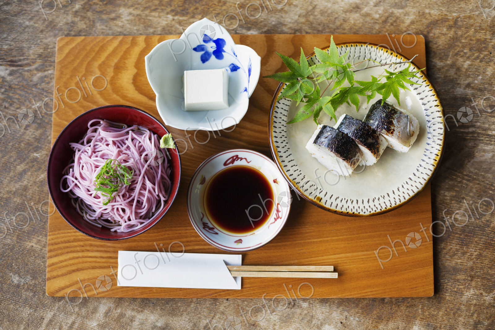 High angle close up of Sushi, Tofu, Noodles and Soy Sauce on a table in Japanese…