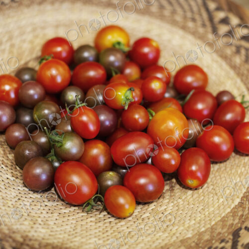 High angle close up of a bowl of fresh tomatoes in a farm shop. High angle close up of a bowl of fresh tomatoes in a farm shop.
