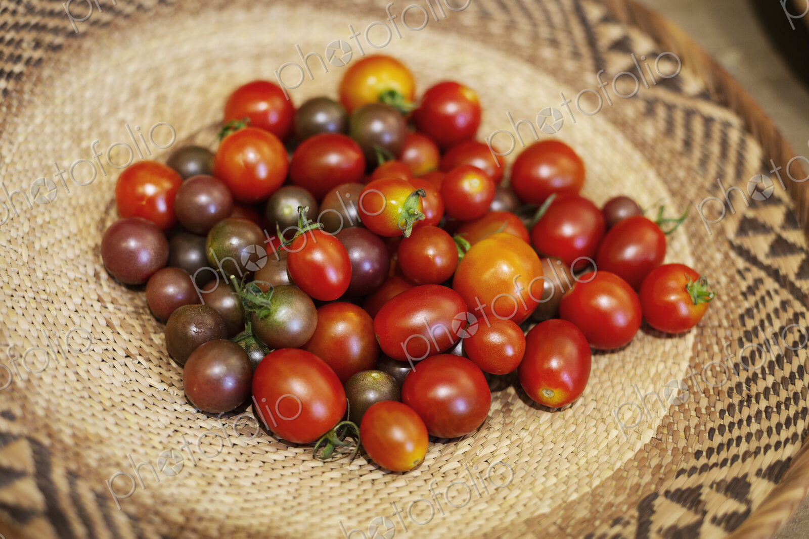 High angle close up of a bowl of fresh tomatoes in a farm shop.