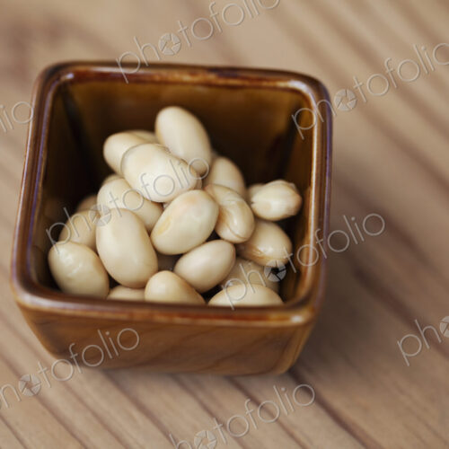 High angle close up of a bowl of white beans in a vegetarian cafe. High angle close up of a bowl of white beans in a vegetarian cafe.