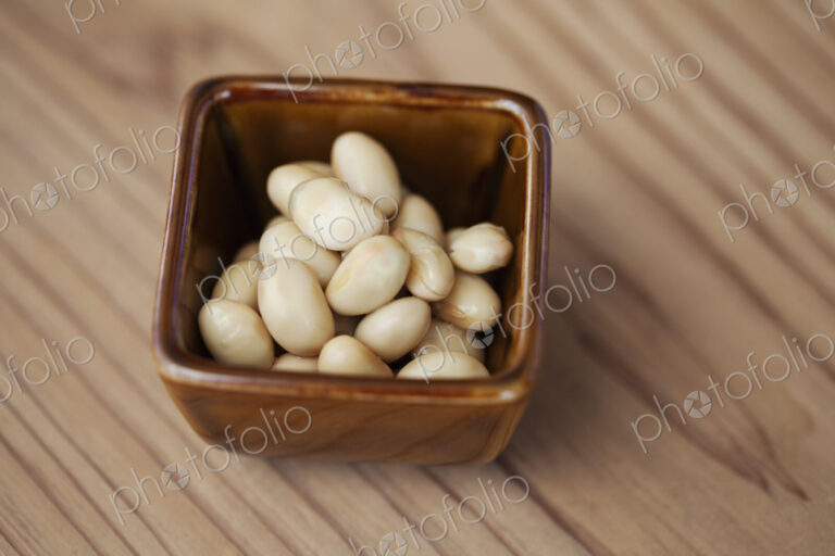 High angle close up of a bowl of white beans in a vegetarian cafe.