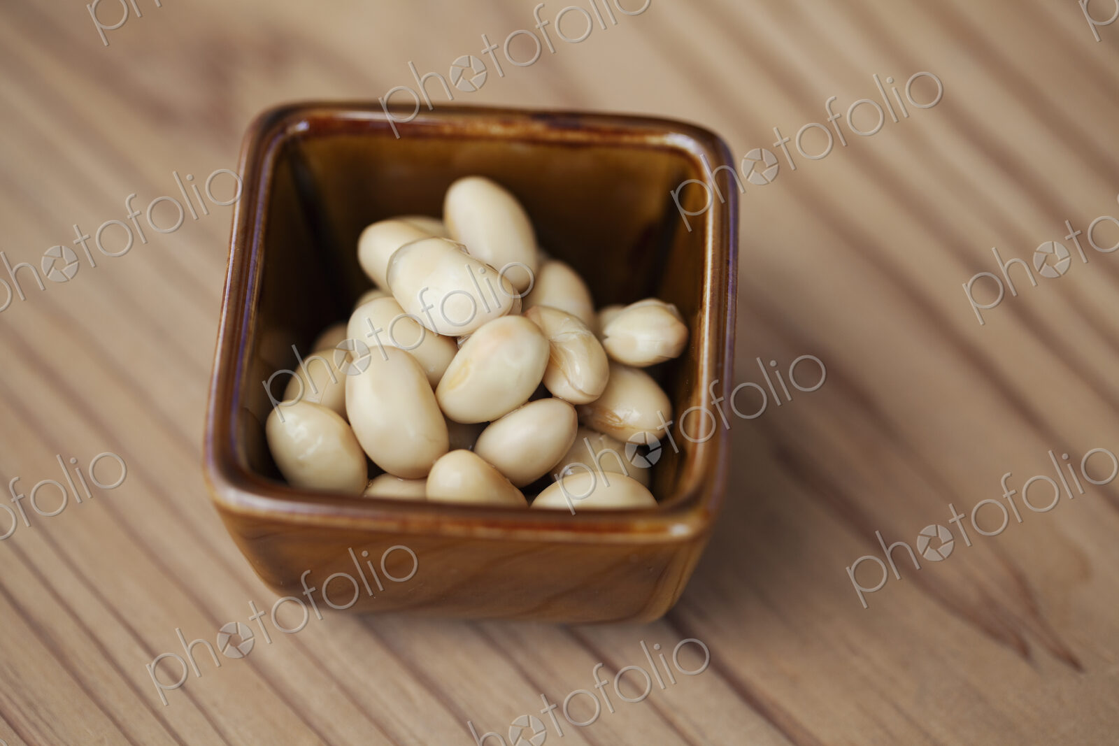 High angle close up of a bowl of white beans in a vegetarian cafe.