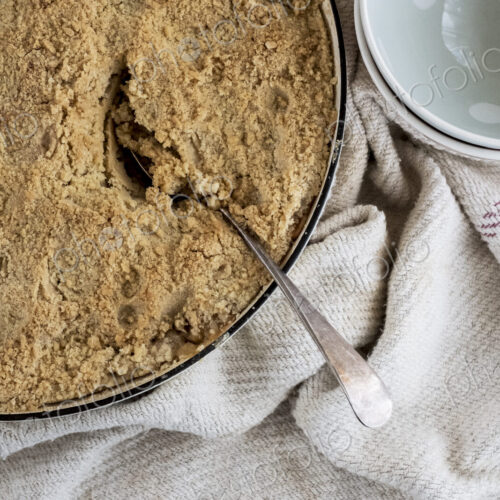 High angle close up of a freshly baked apple and blueberry crumble.