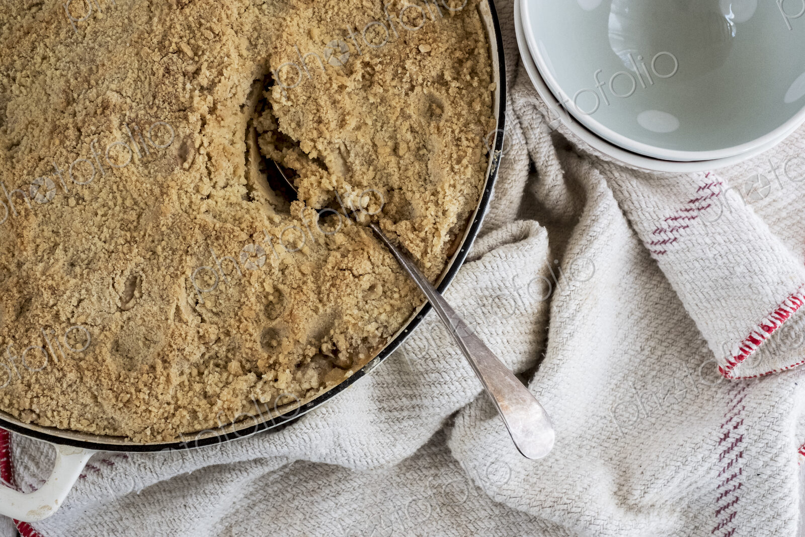 High angle close up of a freshly baked apple and blueberry crumble.