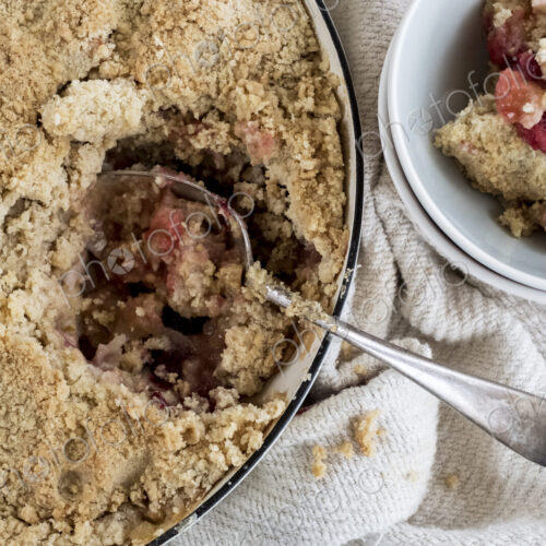 High angle close up of a freshly baked apple and blueberry crumble. High angle close up of a freshly baked apple and blueberry crumble.