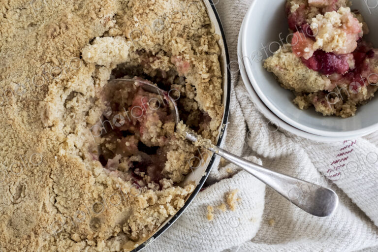 High angle close up of a freshly baked apple and blueberry crumble.
