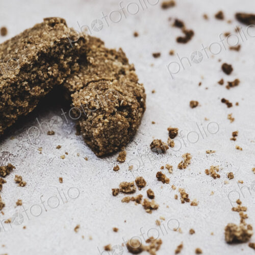 High angle close up of a freshly baked chocolate cookie broken in half. High angle close up of a freshly baked chocolate cookie broken in half.