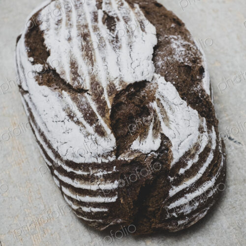 High angle close up of a freshly baked loaf of brown bread. High angle close up of a freshly baked loaf of brown bread.