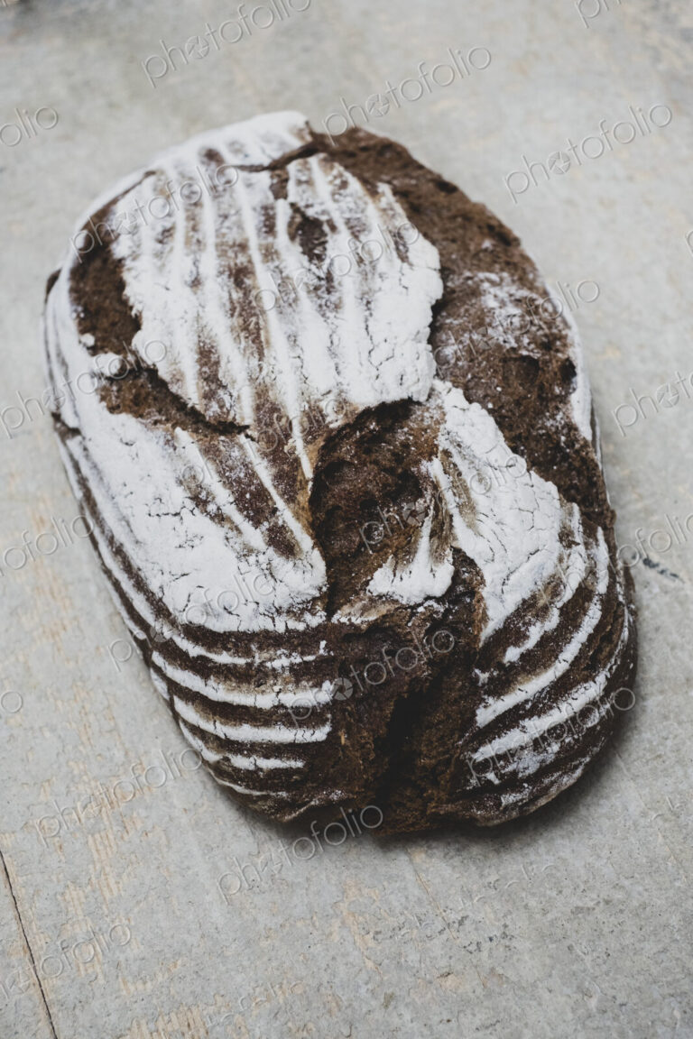 High angle close up of a freshly baked loaf of brown bread.