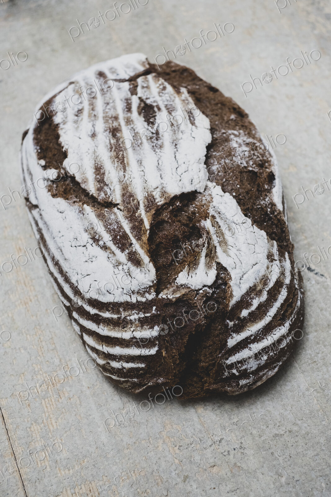 High angle close up of a freshly baked loaf of brown bread.