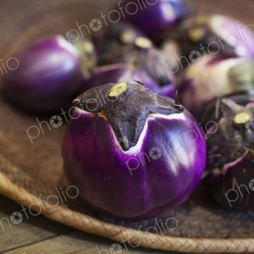 High angle close up of a selection of fresh purple aubergines in a farm shop. High angle close up of a selection of fresh purple aubergines in a farm shop.