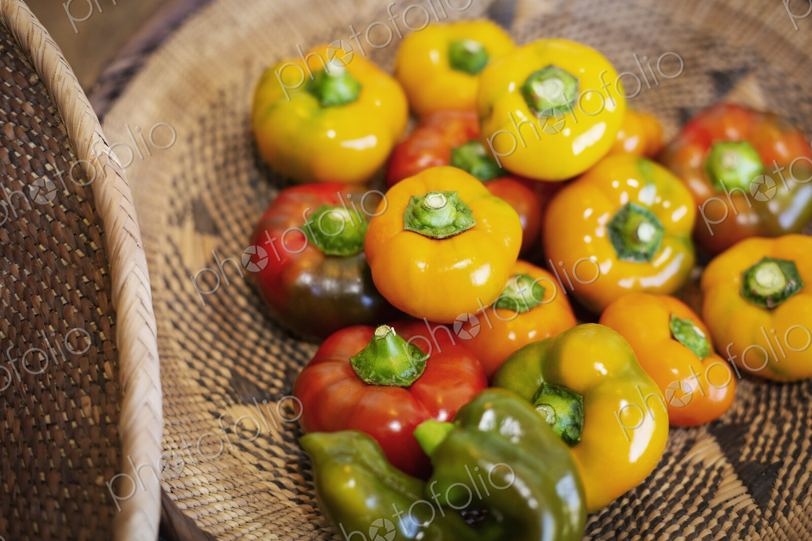 High angle close up of a selection of fresh red and yellow peppers in a farm shop.
