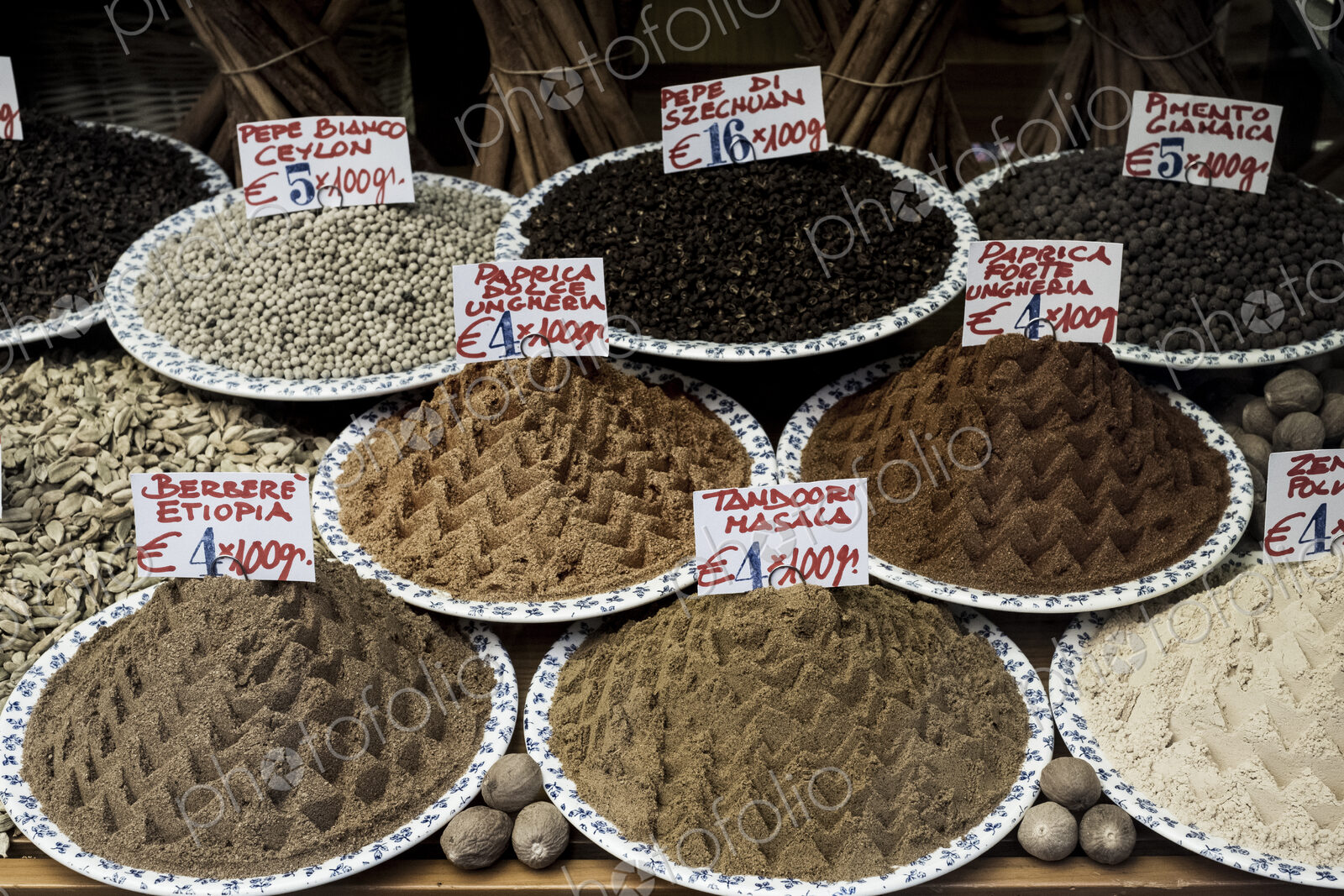 High angle close up of a selection of peppers and spices at an Italian market stall.