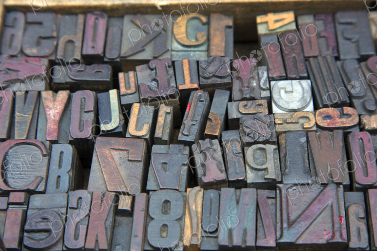 High angle close up of a selection of wood print keys in a variety of fonts.