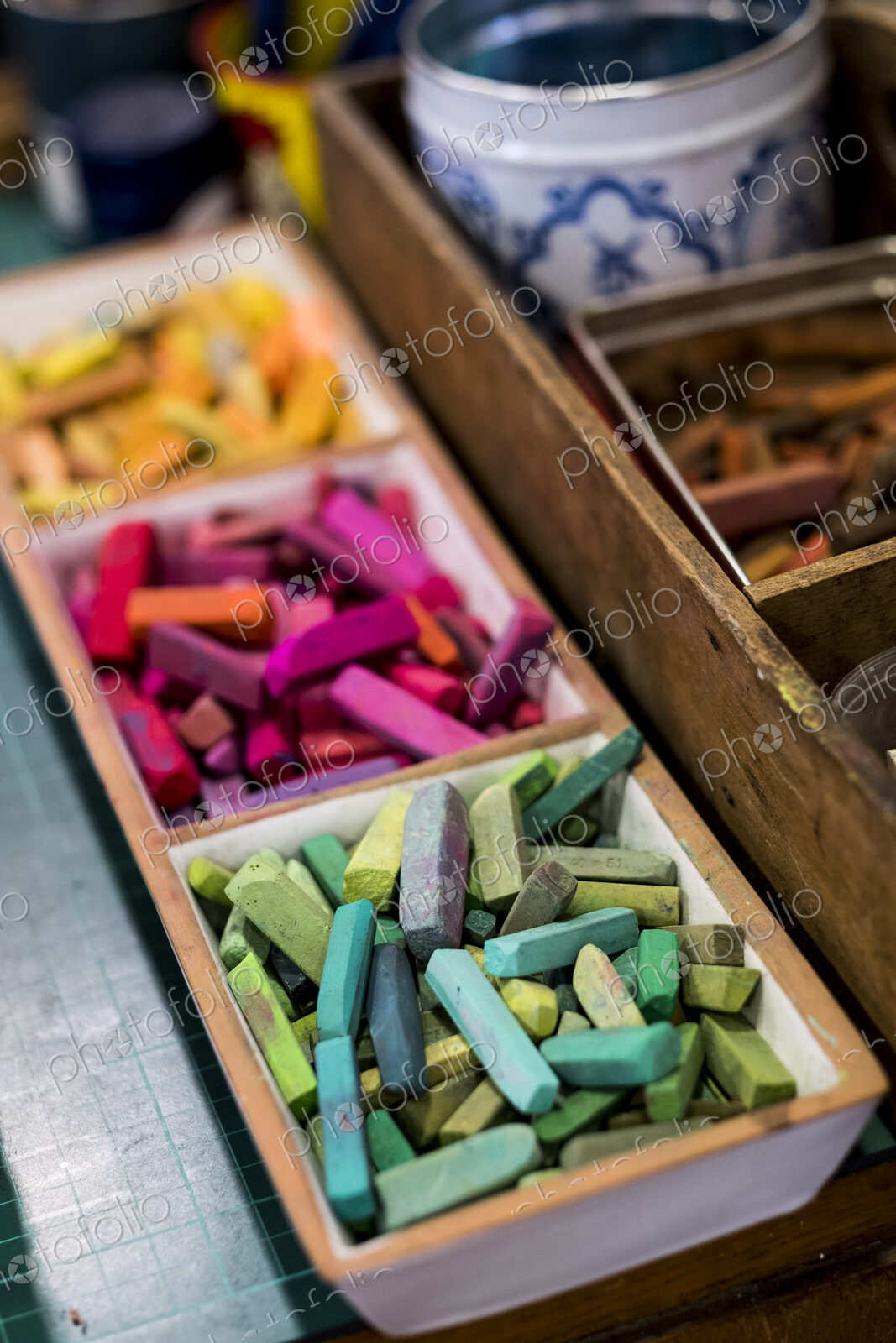 High angle close up of artist’s crayons in a variety of vibrant colours.