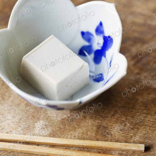 High angle close up of bowl of tofu on a table in Japanese restaurant. High angle close up of bowl of tofu on a table in Japanese restaurant.