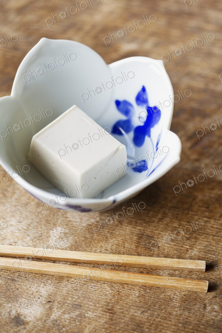 High angle close up of bowl of tofu on a table in Japanese restaurant.