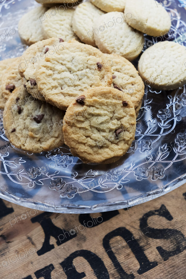 High angle close up of chocolate chip cookies on a glass plate.