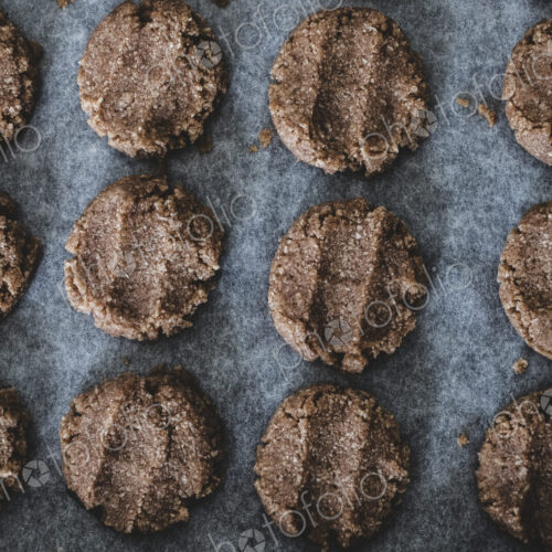 High angle close up of chocolate cookie dough on a baking tray. High angle close up of chocolate cookie dough on a baking tray.