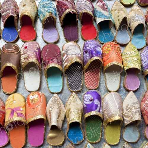 High angle close up of colourful leather slippers at a traditional North African market.