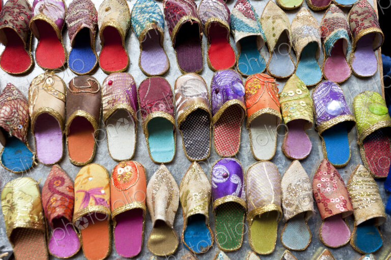 High angle close up of colourful leather slippers at a traditional North African market.