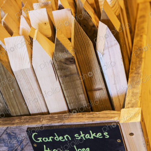 High angle close up of crate with garden stakes made from recycled wood. High angle close up of crate with garden stakes made from recycled wood.