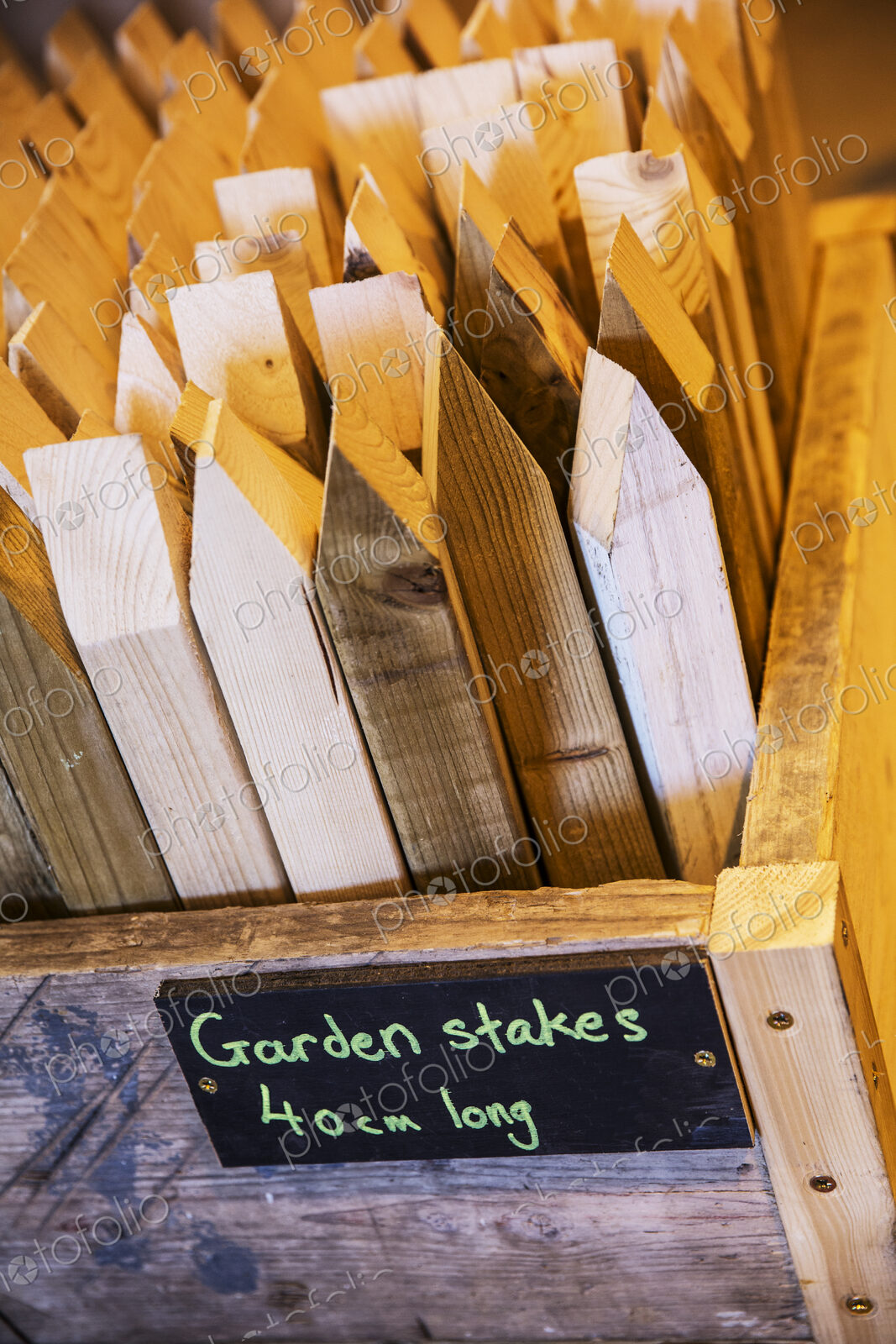 High angle close up of crate with garden stakes made from recycled wood.