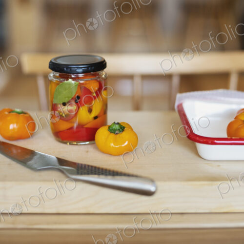 High angle close up of fresh vegetables and knife on wooden cutting board. High angle close up of fresh vegetables and knife on wooden cutting board.