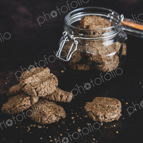 High angle close up of freshly baked chocolate cookies in a glass jar. High angle close up of freshly baked chocolate cookies in a glass jar.